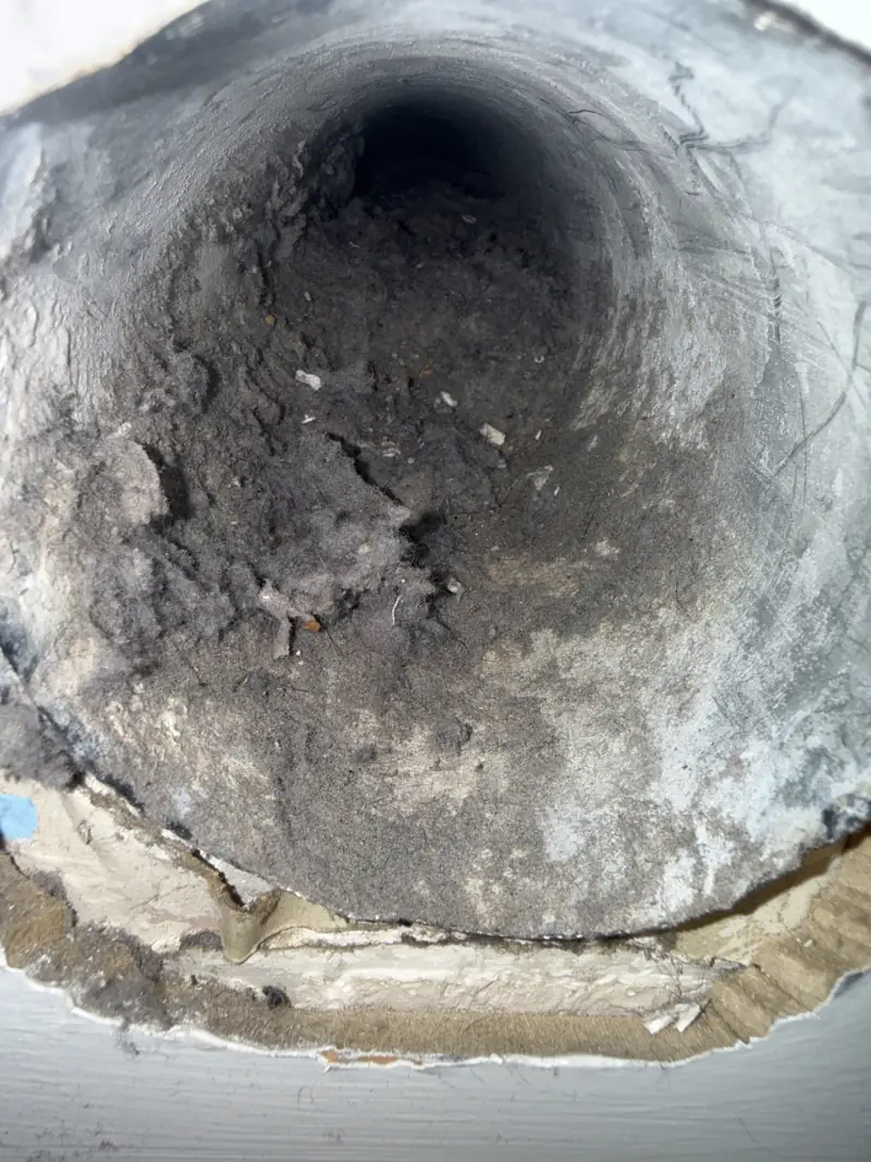 Dryer vent duct before cleaning, coated with heavy lint