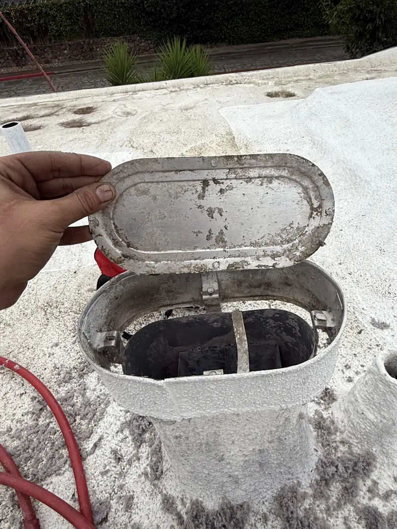 Rooftop dryer vent cap packed with lint before cleaning